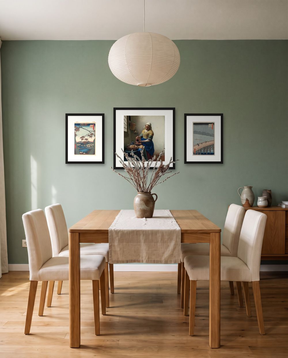 Three in a row: Utagawa Hiroshige, Maples at Mama and Johannes Vermeer, The Milkmaid and Utagawa Hiroshige, Sudden Shower over Shin-Ohashi Bridge and Atake in black frames – art for sage green walls, shown to scale